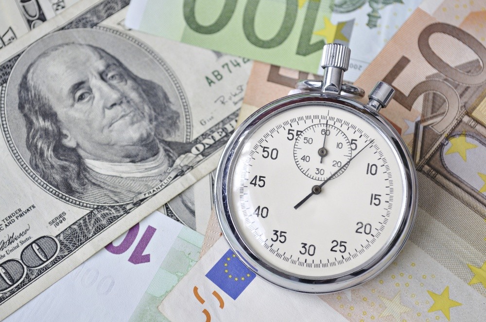 Wibest – EUR-USD: A stopwatch over Euro and US dollar notes.